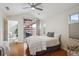 Bright bedroom features hardwood floors, ceiling fan, and sliding glass doors to a private patio at 8638 Gold Peak Dr # D, Highlands Ranch, CO 80130