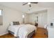 Bright bedroom featuring a ceiling fan, custom closet, and hardwood floors at 8638 Gold Peak Dr # D, Highlands Ranch, CO 80130