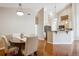 Open-concept dining room features hardwood floors and pendant lighting at 8638 Gold Peak Dr # D, Highlands Ranch, CO 80130
