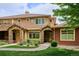 Inviting two-story townhome with stone accents, manicured lawn and front yard landscaping at 8638 Gold Peak Dr # D, Highlands Ranch, CO 80130