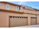Exterior shot featuring 2-car garage and a view of the roof top deck above at 8638 Gold Peak Dr # D, Highlands Ranch, CO 80130