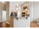 Open kitchen features stainless steel appliances, granite countertops, and breakfast bar at 8638 Gold Peak Dr # D, Highlands Ranch, CO 80130