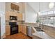 Bright kitchen with stainless steel appliances, granite countertops, and lots of natural light at 8638 Gold Peak Dr # D, Highlands Ranch, CO 80130