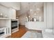 Open concept living space with hardwood floors, fireplace, and adjoining kitchen at 8638 Gold Peak Dr # D, Highlands Ranch, CO 80130