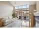 Open living room boasts a fireplace, high ceilings, and natural light at 8638 Gold Peak Dr # D, Highlands Ranch, CO 80130