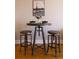 Cozy dining area with a high top table, wooden stools and Paris themed decorations at 1625 Larimer St # 2708, Denver, CO 80202