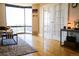 Well-lit living room with hardwood floors, French doors, and large windows with a city view at 1625 Larimer St # 2708, Denver, CO 80202