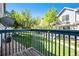 Balcony view of trees and lawn with a blue railing at 19172 E Arkansas Dr # 106, Aurora, CO 80017