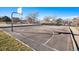 Outdoor basketball court surrounded by a fence and trees, perfect for recreational games at 19172 E Arkansas Dr # 106, Aurora, CO 80017