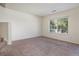 Bright room offers a serene atmosphere with a large window, neutral paint, and plush carpeting at 19172 E Arkansas Dr # 106, Aurora, CO 80017