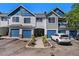 Attractive townhome featuring attached garages and appealing blue and gray color scheme on a sunny day at 19172 E Arkansas Dr # 106, Aurora, CO 80017