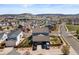 Aerial view of a two-story home boasting a three-car garage, surrounded by manicured lawns and mature trees at 4401 Hydrangea Way, Castle Rock, CO 80109