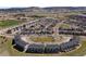 An aerial view showcases a mixed residential community with modern apartments and well-kept single-Gathering homes at 4401 Hydrangea Way, Castle Rock, CO 80109