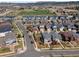 Aerial view of residential area with green spaces, tree lined streets, and neighborhood school with fields at 4401 Hydrangea Way, Castle Rock, CO 80109