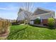 Large backyard with lush green grass and mature trees providing shade at 4401 Hydrangea Way, Castle Rock, CO 80109