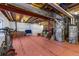 Spacious unfinished basement with mechanical systems and red painted floors ready for future customization at 4401 Hydrangea Way, Castle Rock, CO 80109