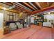 Unfinished basement with exposed ceiling and red painted floors ready for your customization with chairs for relaxation at 4401 Hydrangea Way, Castle Rock, CO 80109