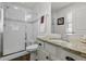 Well-lit bathroom featuring granite counters and a walk-in shower with glass doors at 4401 Hydrangea Way, Castle Rock, CO 80109