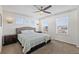 Spacious bedroom features natural light from multiple windows and a modern ceiling fan at 4401 Hydrangea Way, Castle Rock, CO 80109