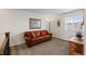 Comfortable bonus room with natural light, a leather sofa, and an area rug at 4401 Hydrangea Way, Castle Rock, CO 80109