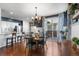 Dining area next to the kitchen, featuring hardwood floors, a chandelier, and a patio door at 4401 Hydrangea Way, Castle Rock, CO 80109