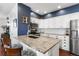 Bright kitchen featuring granite countertops, stainless steel appliances, and white cabinetry at 4401 Hydrangea Way, Castle Rock, CO 80109