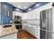 Modern kitchen featuring granite countertops, stainless steel appliances, and white cabinets at 4401 Hydrangea Way, Castle Rock, CO 80109