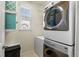 Bright laundry room with stacked washer/dryer and convenient shelving at 4401 Hydrangea Way, Castle Rock, CO 80109