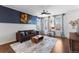 Bright living room featuring a stylish couch and hardwood floors at 4401 Hydrangea Way, Castle Rock, CO 80109