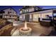 Outdoor patio with a fire pit and hot tub, perfect for entertaining and enjoying backyard gatherings at 785 Delechant Dr, Erie, CO 80516