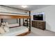 Unique bunk beds, complemented by stylish furnishings and a modern TV, create a fun and functional bedroom space at 785 Delechant Dr, Erie, CO 80516