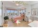 A lovely bedroom with a wooden bed frame, light pink duvet, and windows for natural light at 785 Delechant Dr, Erie, CO 80516