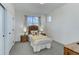 Cozy bedroom with a large window, soft carpet, and neutral decor; perfect for relaxation at 785 Delechant Dr, Erie, CO 80516