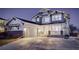 Charming two-story home showcasing a well-manicured lawn, covered porch, and attached two-car garage at 785 Delechant Dr, Erie, CO 80516