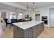 Open-concept kitchen featuring a spacious island with seating, modern appliances, and a seamless flow to the dining area at 785 Delechant Dr, Erie, CO 80516