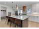 Modern kitchen with a large island, stainless steel appliances, and custom cabinetry and fixtures at 785 Delechant Dr, Erie, CO 80516