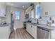 Bright kitchen features stainless steel appliances, modern cabinets and a window above the sink at 785 Delechant Dr, Erie, CO 80516