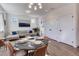 Open-concept living and dining area with hardwood floors, neutral colors, and abundant natural light at 785 Delechant Dr, Erie, CO 80516