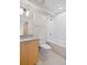 Bright bathroom with granite vanity, modern lighting, and a tiled bathtub with shower at 1878 W 32Nd Ave, Denver, CO 80211