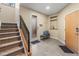 Welcoming entryway features tile floors, storage, and a staircase with a modern railing at 1878 W 32Nd Ave, Denver, CO 80211