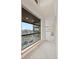 Hallway bathed in natural light from a large window, showcasing city views and neutral decor at 1878 W 32Nd Ave, Denver, CO 80211