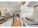 Bright, modern kitchen with stainless steel appliances, a breakfast bar, and a seamless transition into the living area at 1878 W 32Nd Ave, Denver, CO 80211