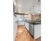 Spacious kitchen features stainless steel appliances, white cabinets, and an island with a breakfast bar at 1878 W 32Nd Ave, Denver, CO 80211