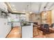 Well-equipped kitchen features modern appliances, sleek countertops, and a breakfast bar adjacent to dining area at 1878 W 32Nd Ave, Denver, CO 80211