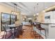 Open-concept living space featuring a dining area, modern kitchen with bar seating, and a cozy living room at 1878 W 32Nd Ave, Denver, CO 80211