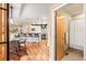 Open-concept area showing modern kitchen, dining and bath, with a doorway leading to the bathroom at 1878 W 32Nd Ave, Denver, CO 80211