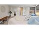 Bright main bedroom featuring a modern design with a padded bench, plant, and light blue accents at 1878 W 32Nd Ave, Denver, CO 80211