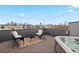 Charming rooftop deck with seating and a hot tub offering views of the city skyline at 1878 W 32Nd Ave, Denver, CO 80211