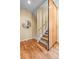 Staircase with wooden handrail, carpeted steps and decorative wall accents, complemented by stylish hardwood floors at 1878 W 32Nd Ave, Denver, CO 80211