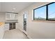 Chic wet bar featuring a wine refrigerator, cabinetry, and city views from the window at 1878 W 32Nd Ave, Denver, CO 80211